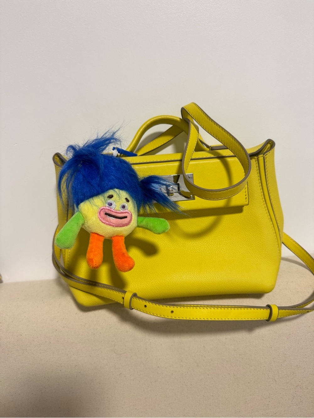Vibrant Yellow Leather Satchel with Playful Charm